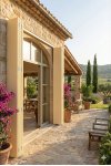 Persienne bois sur mesure beige pliante ouverte sur mas provençal avec terrasse en pierre