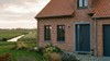 Porte-fenetre PVC 2 ouvrants sur mesure Aluplast - maison en briques dans le Nord
