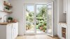 Porte de service PVC 2 vantaux sur mesure – vue intérieure, vantail ouvert sur la terrasse