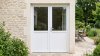 Porte de service PVC semi-vitrée 2 vantaux sur mesure – vue extérieure sur la terrasse